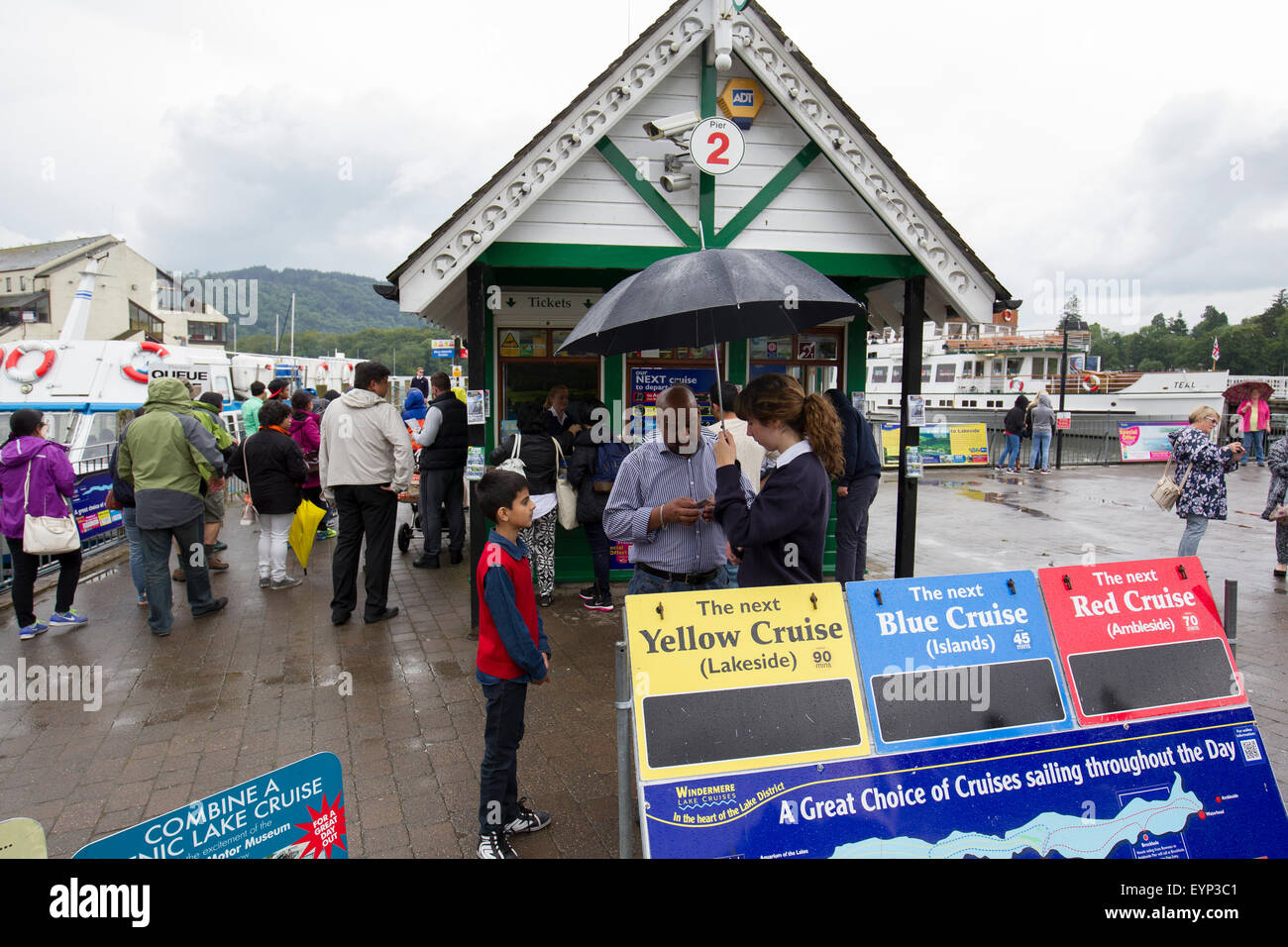 Bowness on Lake Windermere, Cumbria, UK. 2nd Aug, 2015. UK WeatherTourists shelter from the