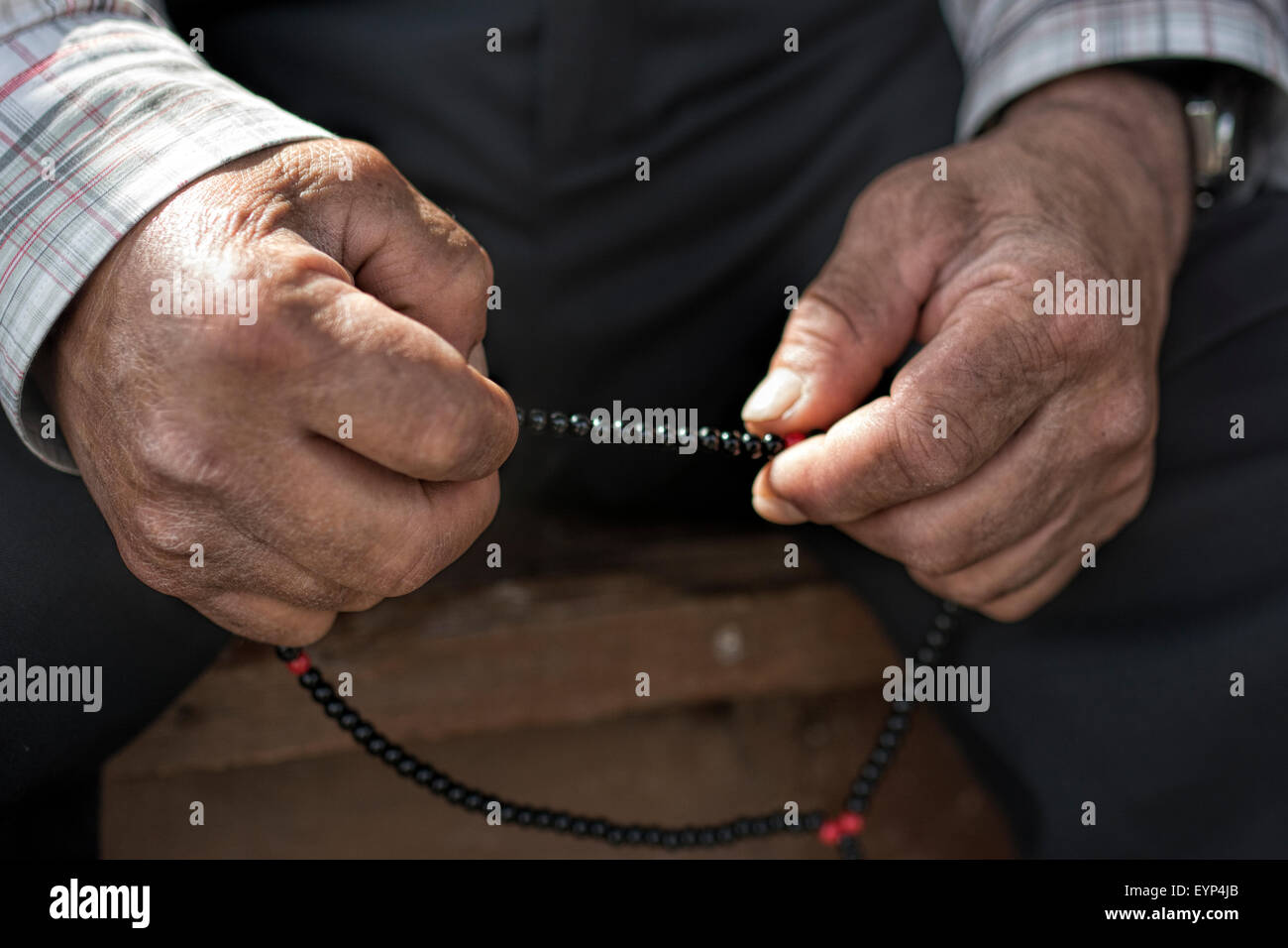 Old muslim Man with rosary praying Stock Photo
