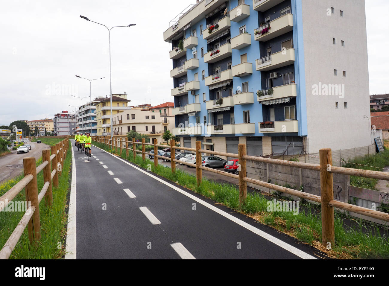 Three touring cyclists riding on an elevated bike path in Pescara. Stock Photo