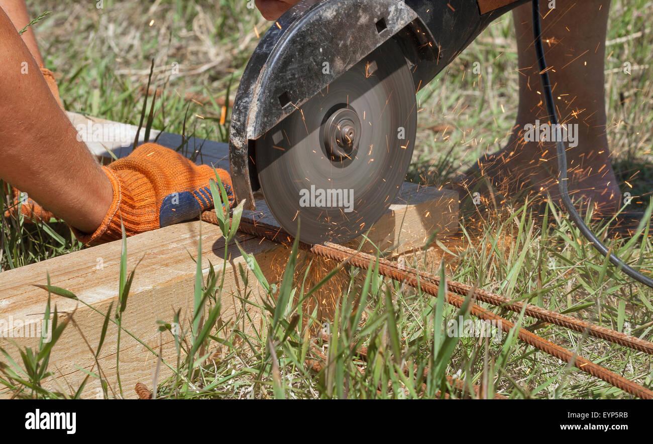 workers cuts rebar circular power saw outdoor closeup Stock Photo