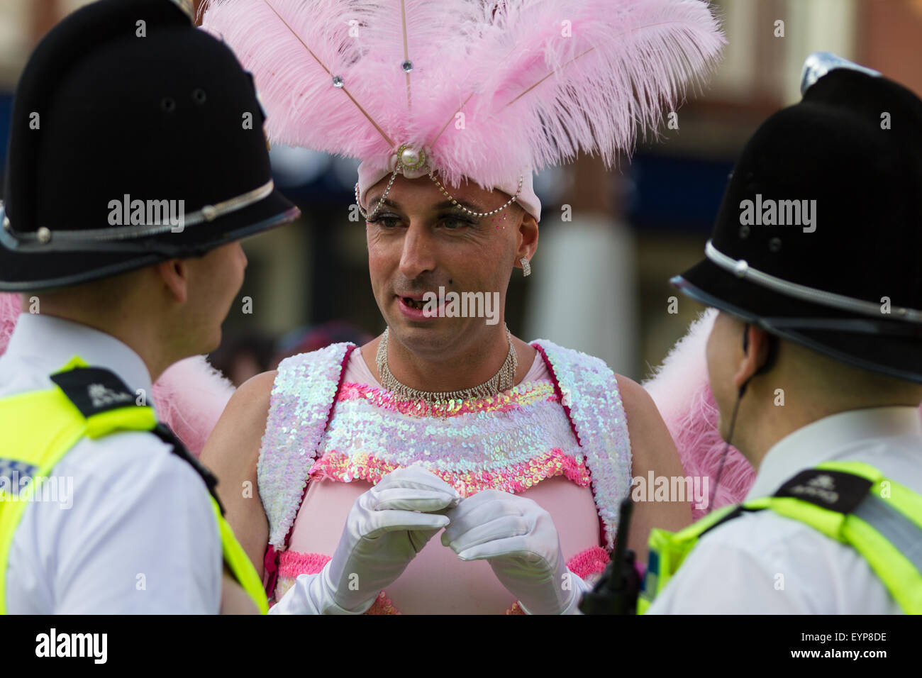 Stockton-on-Tees, UK, Saturday, 1st August, 2015. A male street performer, in full costume as a pink angel, interacts with two officers from Cleveland Police, dressed in their normal police uniform, at Instant Light, the 28th Stockton International Riverside Festival. Credit:  Andrew Nicholson/Alamy Live News Stock Photo