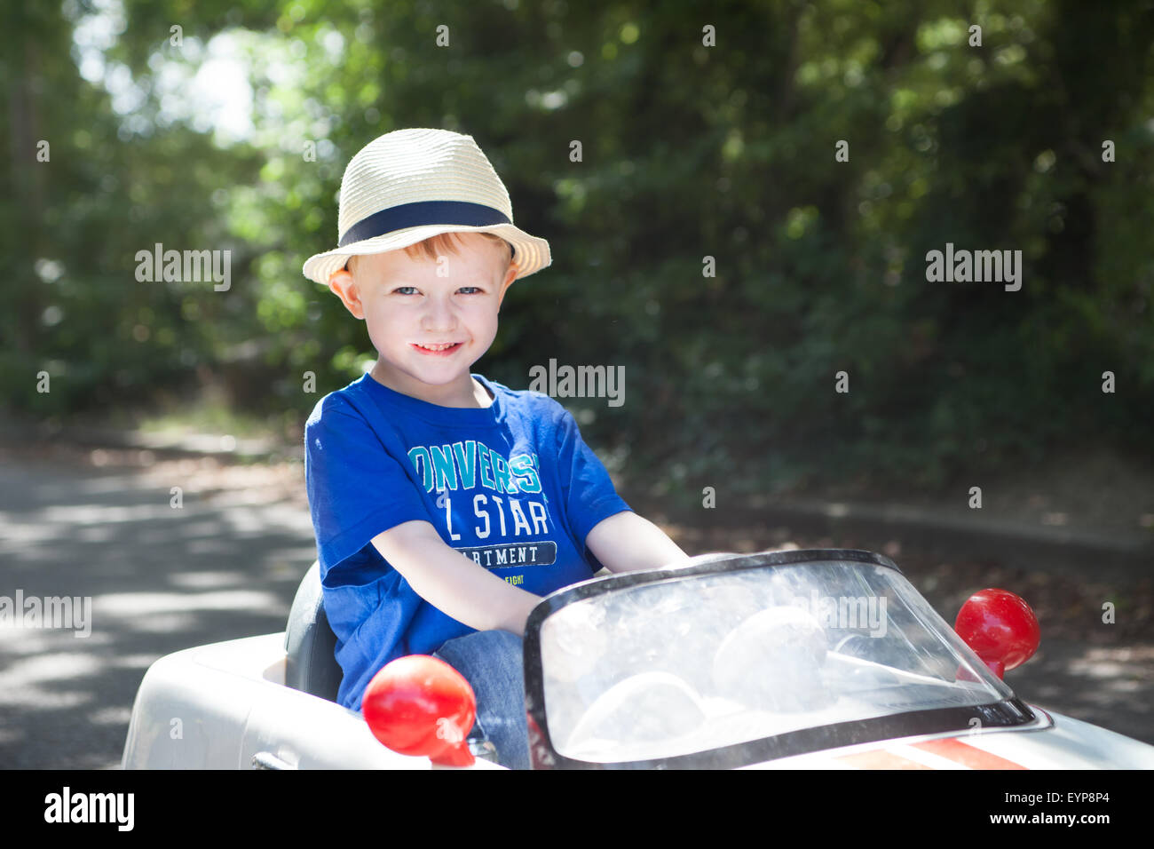 small boy driving car