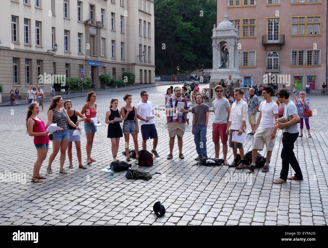 Choir singing singers busking in Place St Jean in Lyon France Stock Photo