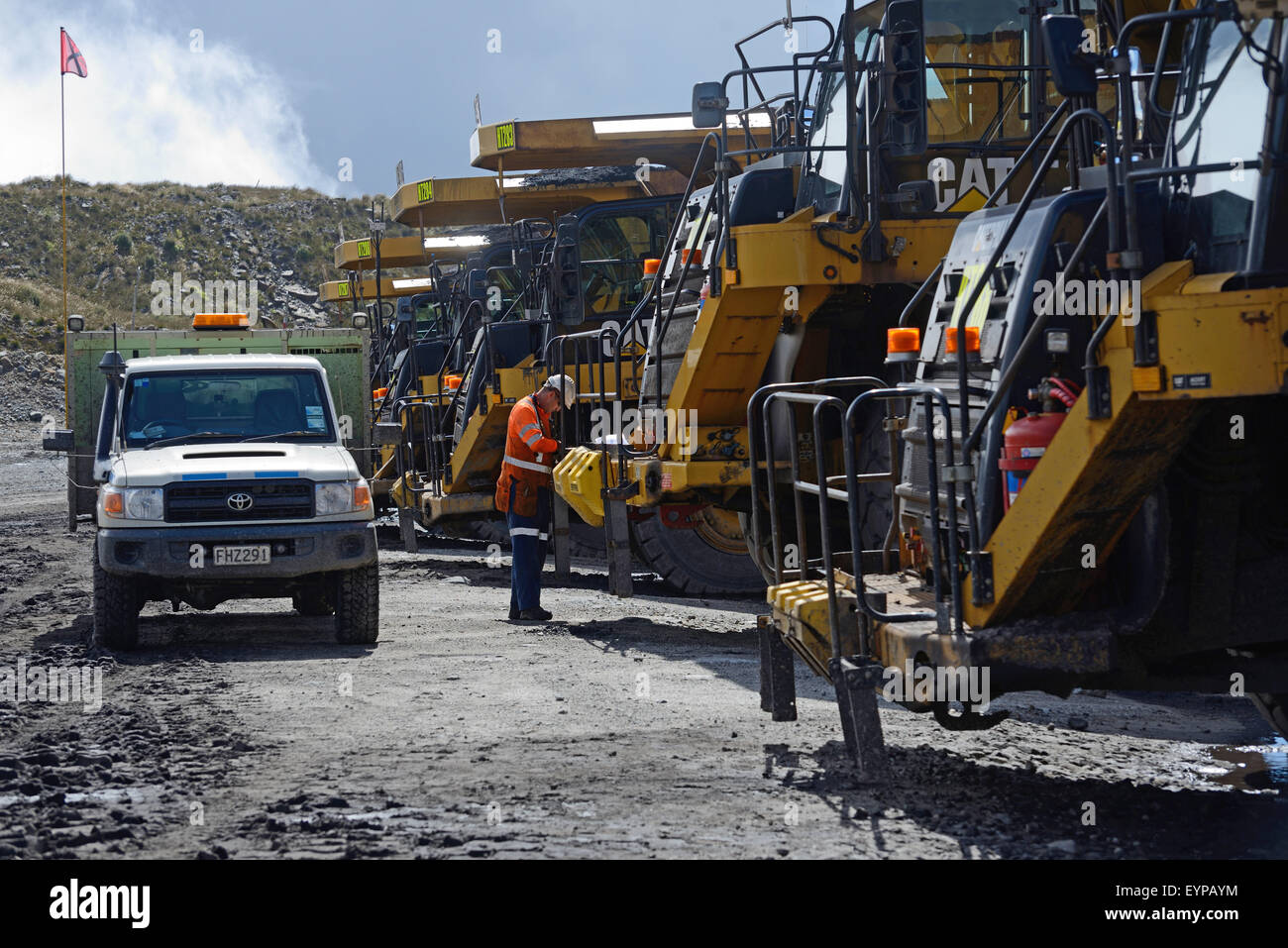 WESTPORT, NEW ZEALAND, MARCH 11, 2015: A mechanic cheks the 70 ton tip trucks at Stockton open cast coal mine Stock Photo