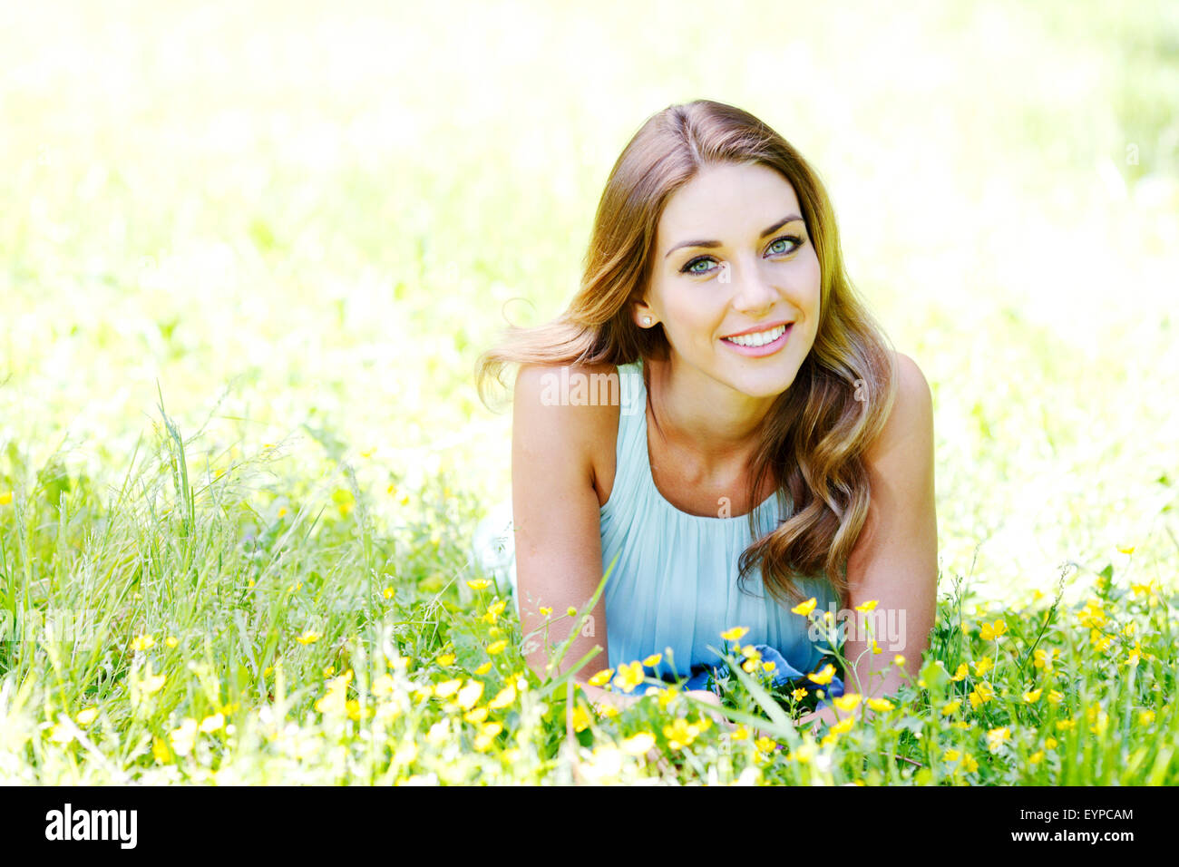 young woman in blue dress lying on grass Stock Photo - Alamy