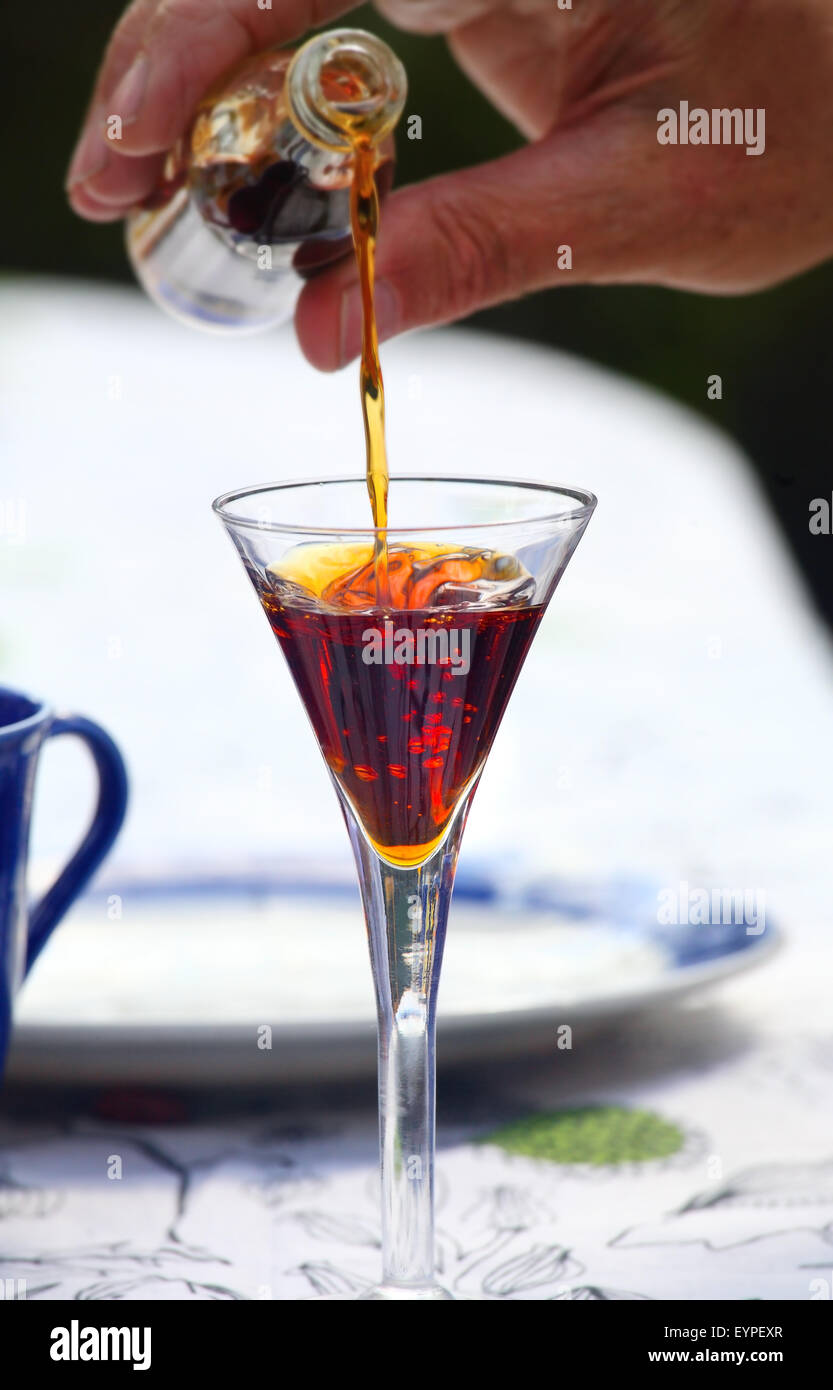 Liqueur being poured into glass Stock Photo