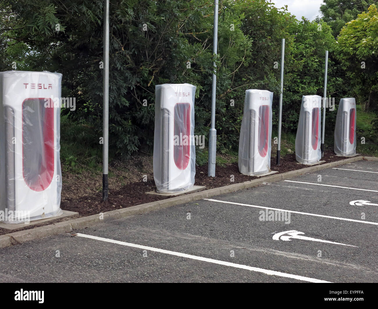 Elon Musk Tesla charging points being implemented on a motorway service area in the UK Stock Photo