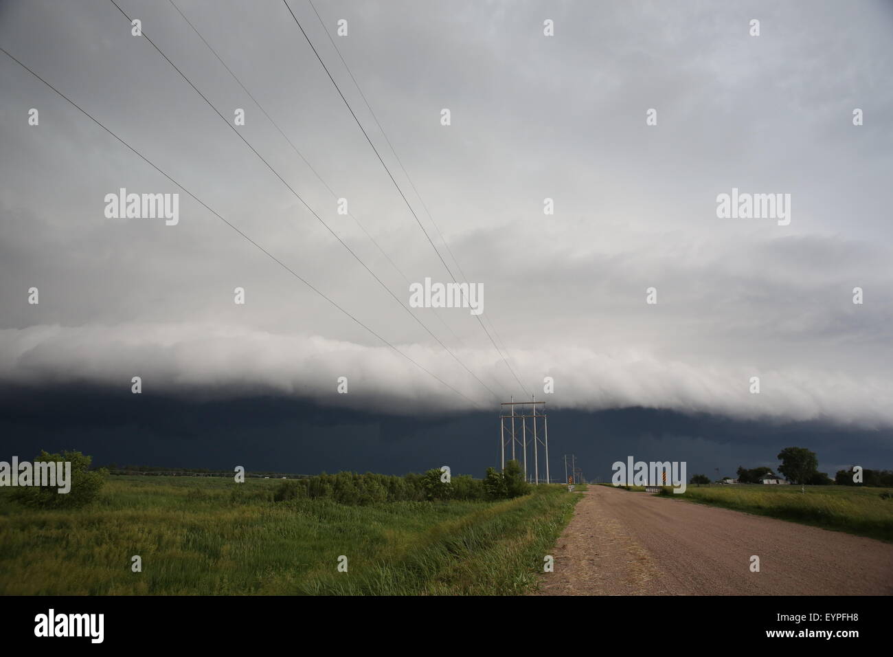 A large shelf cloud rolling over a rural area of Nebraska. Stock Photo
