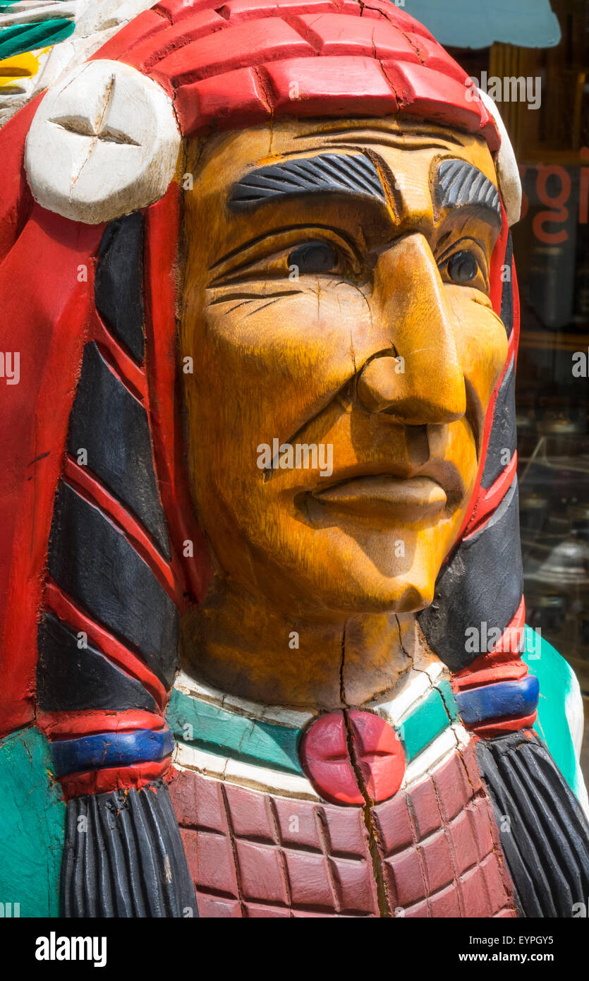 A wooden cigar store Indian carving outside a tobacco shop in Soho in