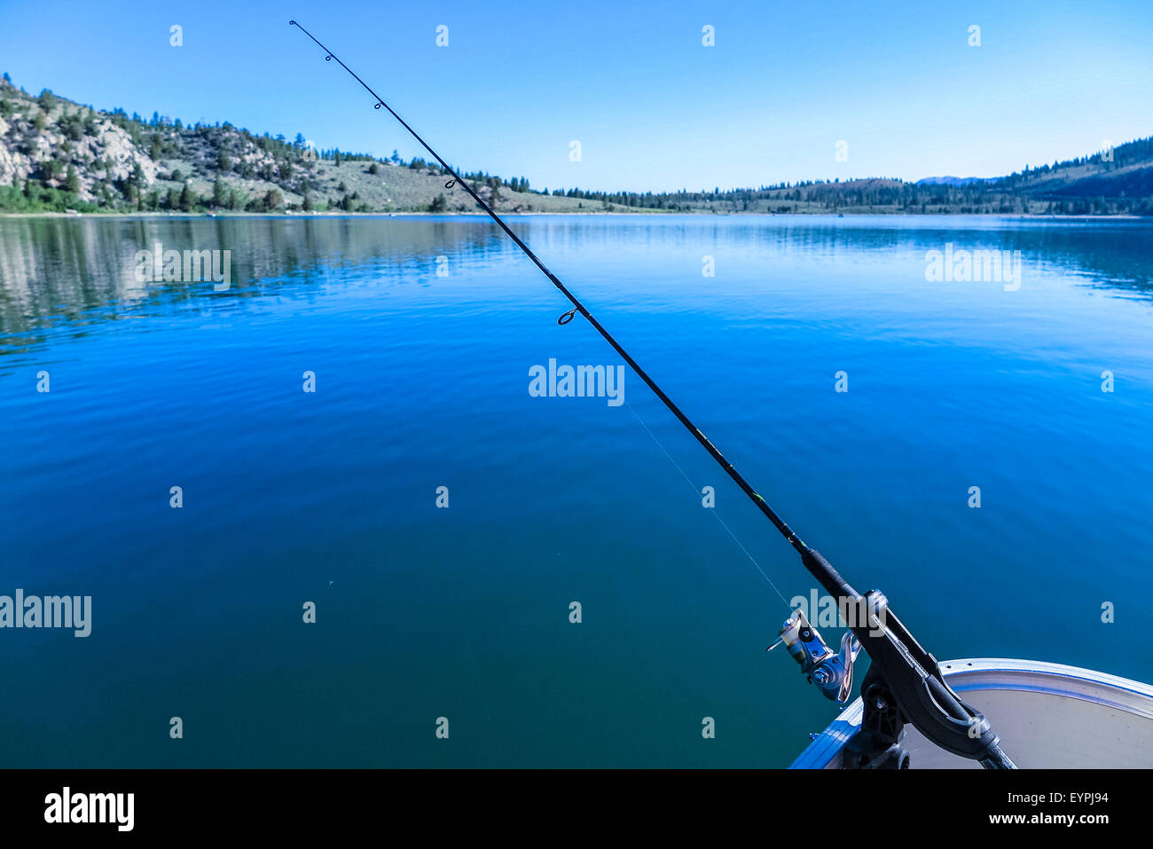 A fishing pole in a holder on Pontoon boat on June Lake in California Stock Photo