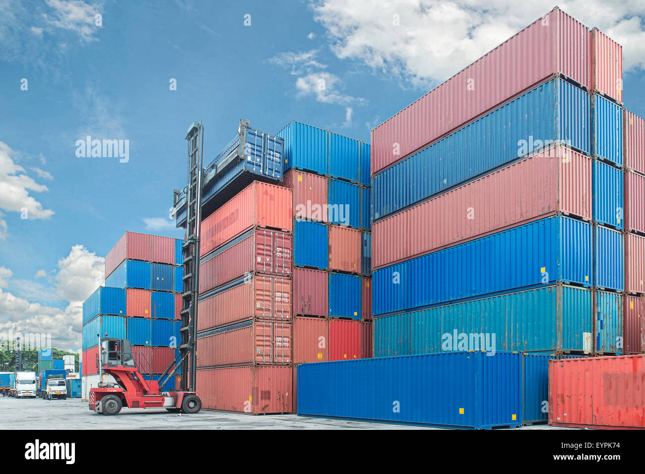 forklift handling container box loading to truck in import export logistic zone Stock Photo