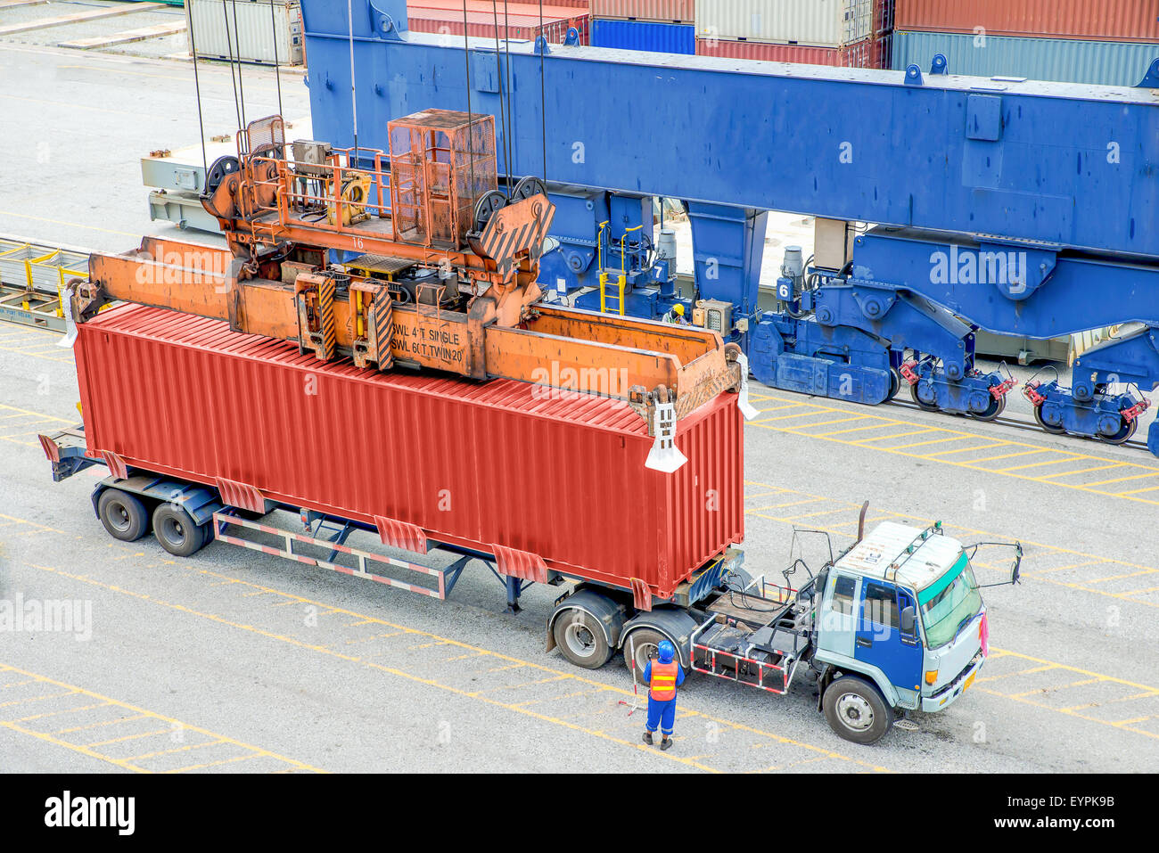 Container truck waiting for loading container box to Cargo ship Stock Photo