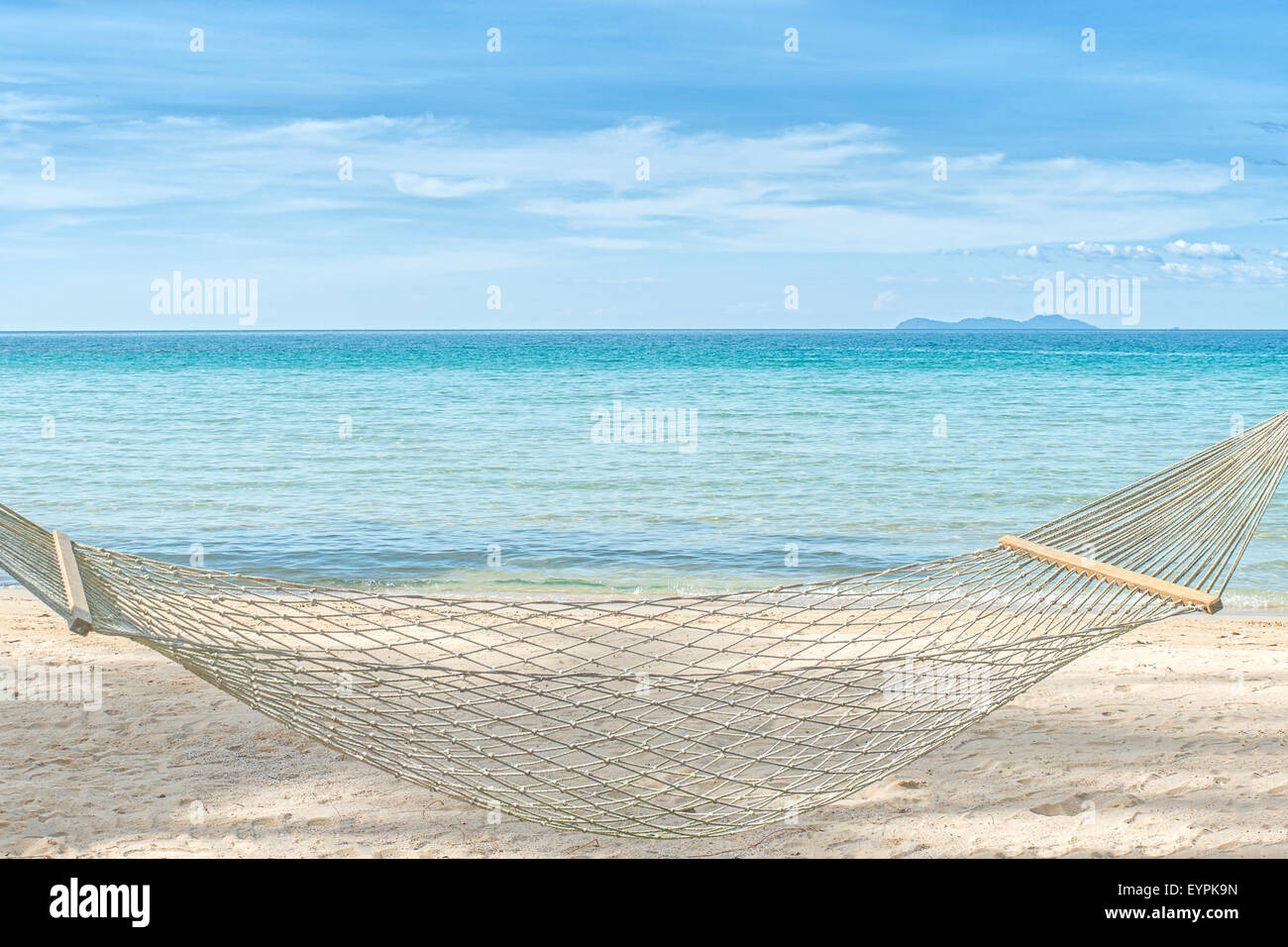 Summer, Travel, Vacation and Holiday concept - Empty hammock between palm trees on tropical beach Stock Photo