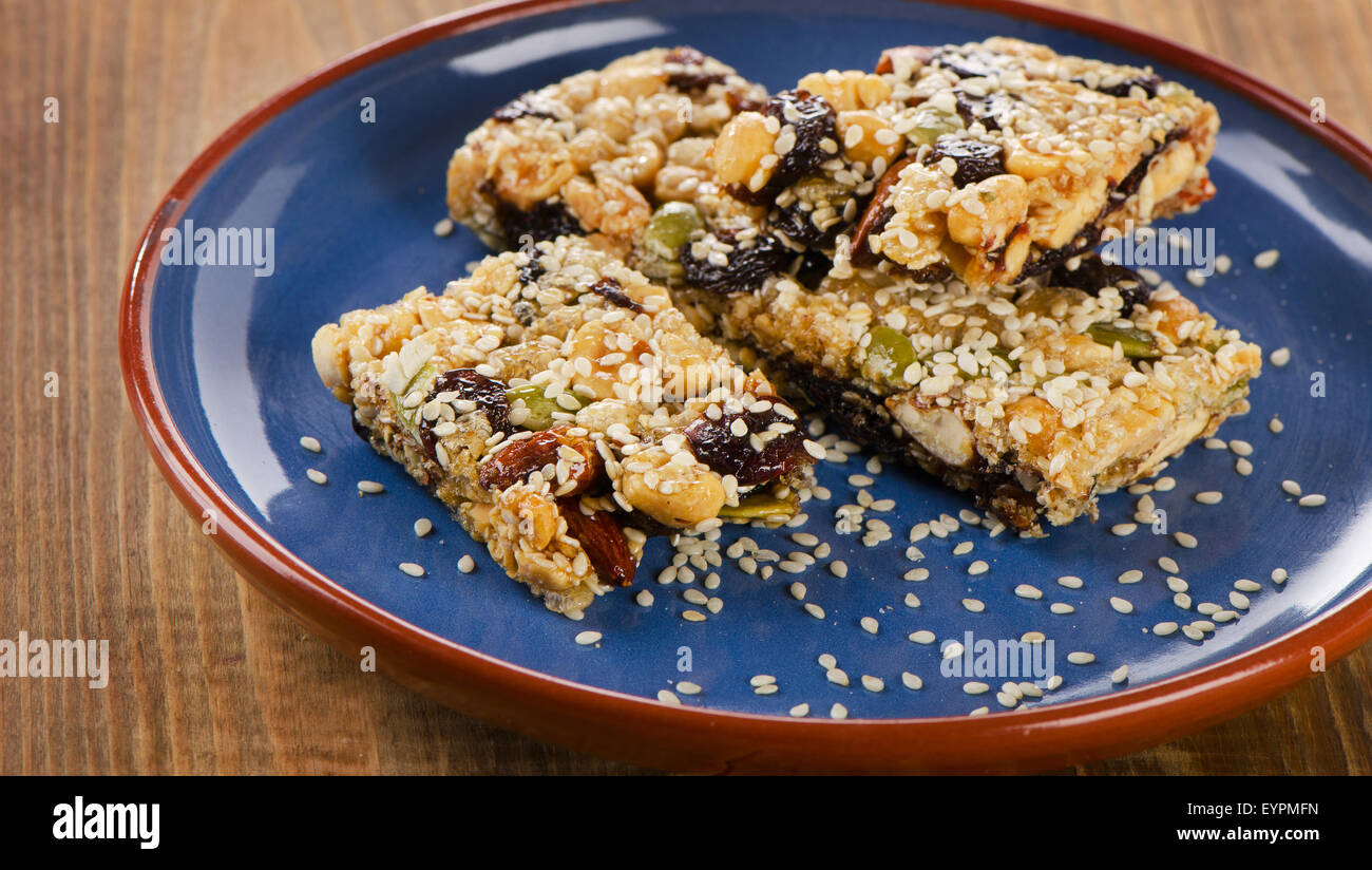 Healthy  granola bars on a blue  plate. Selective focus Stock Photo