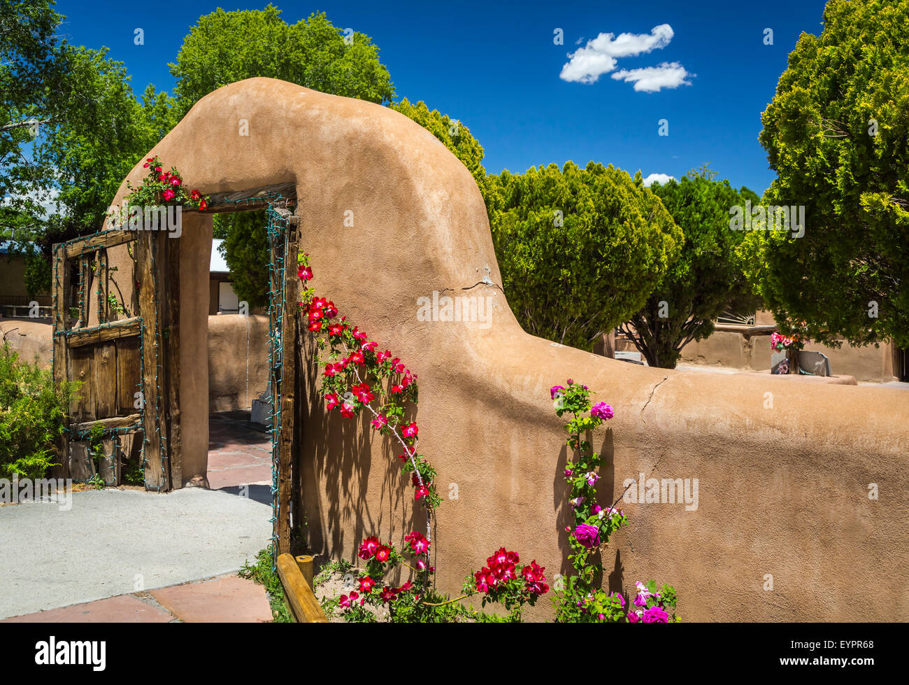 The adobe arch entrance to the  El Santuario de Chimayó Roman Catholic church in Chimayo, New Mexico, USA Stock Photo