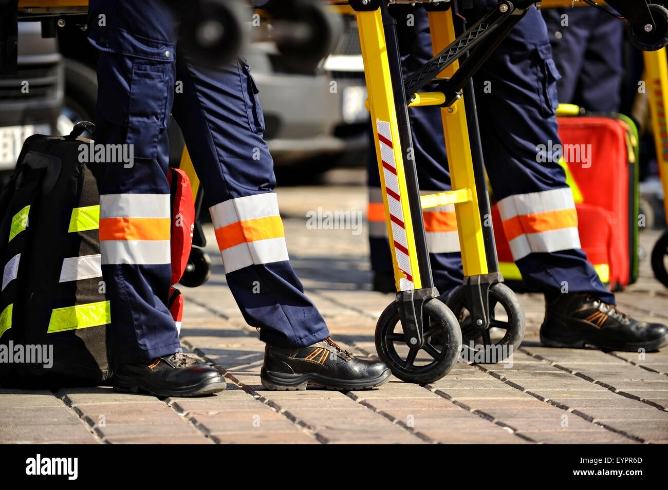Ambulance personnel feet are seen next to emergency equipment Stock Photo