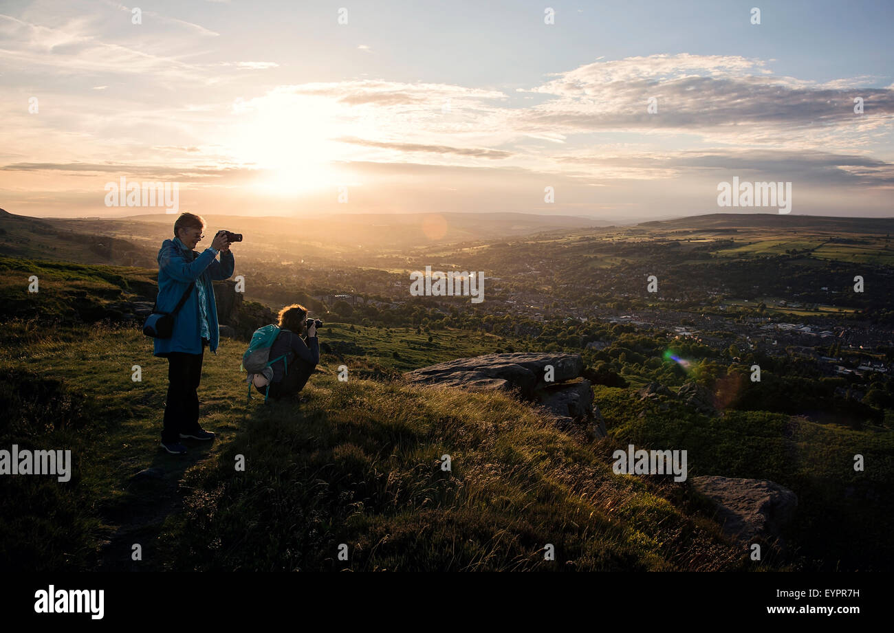 Photographers taking photos on Ilkley Moor view at sunset Stock Photo