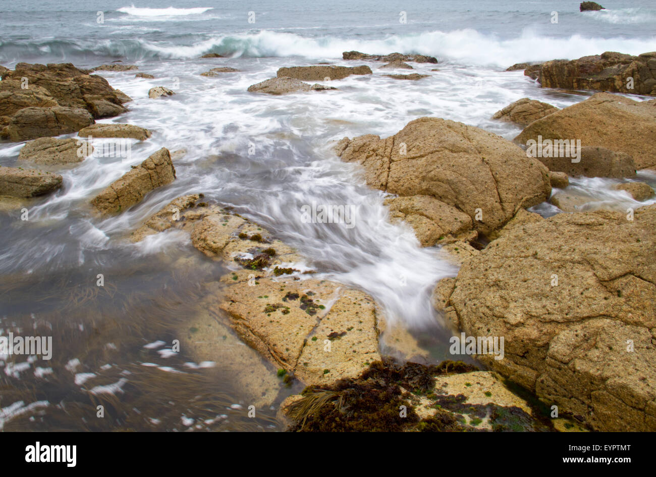 Waves on the rocks and stones on the Atlantic coast of Brittany, France ...