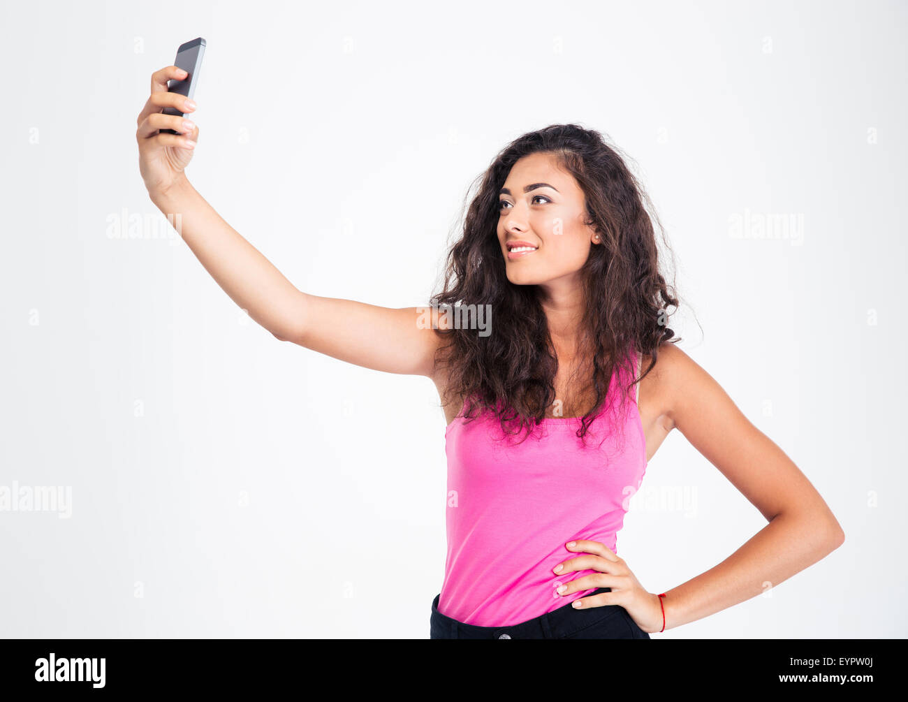 Teen girl making selfie photo on smartphone isolated on a white