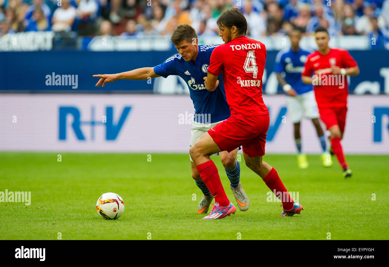 Gelsenkirchen, Germany. 02nd Aug, 2015. Schalke's Klaas-Jan Huntelaar (L) and Enscchede's Georgios Katsikas (R) in action during a soccer friendly match between FC Schalke 04 and FC Twente Enschede at Veltins Arena in Gelsenkirchen, Germany, 02 August 2015. Photo: GUIDO KIRCHNER/dpa/Alamy Live News Stock Photo