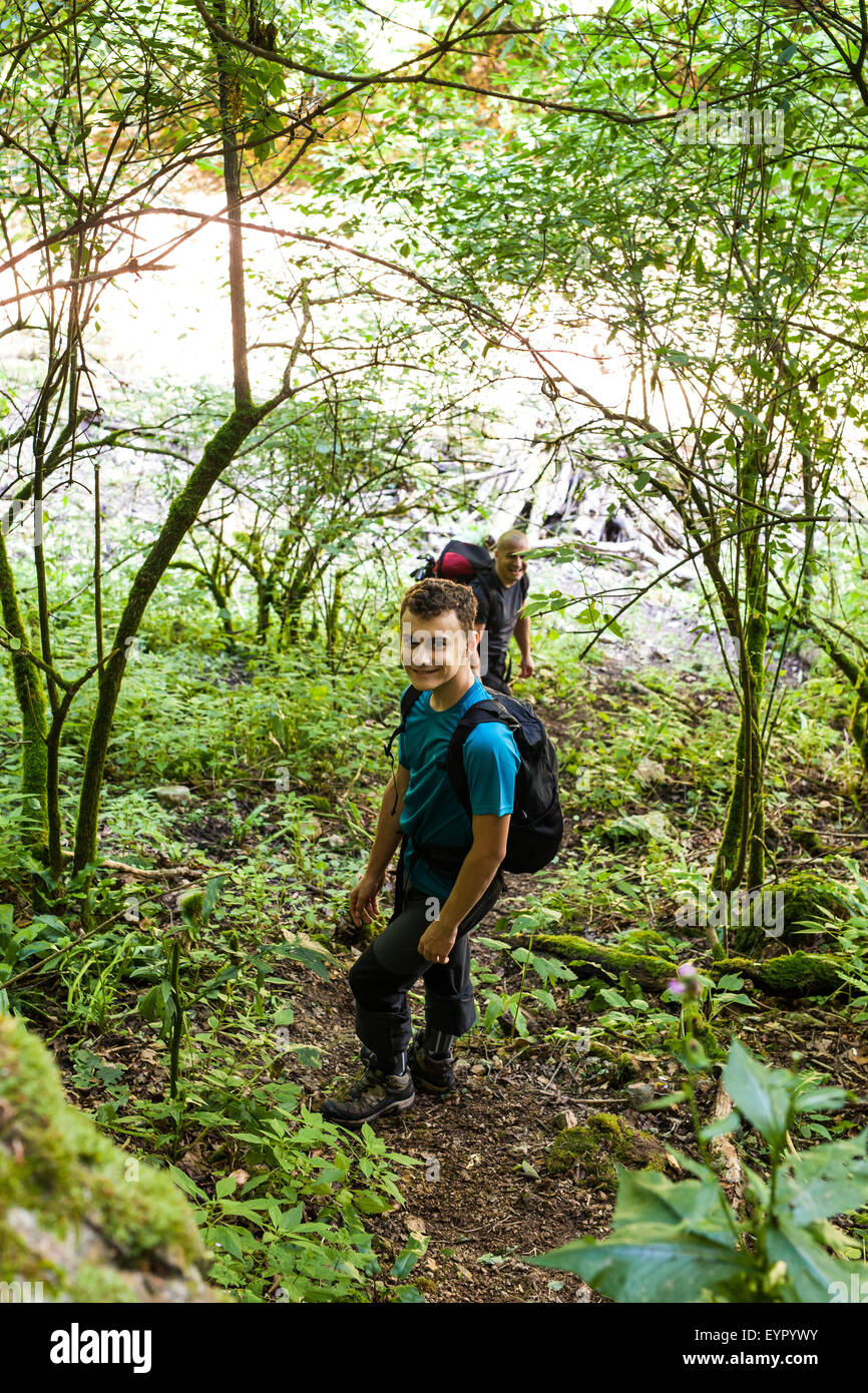 Father and son hiking in forest. Looking at map Stock Photo - Alamy