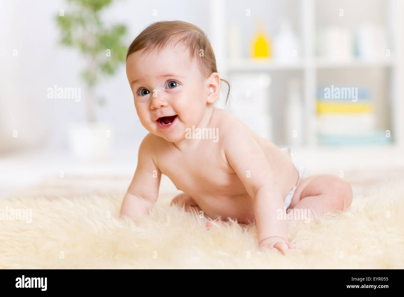 baby sitting on floor at home Stock Photo
