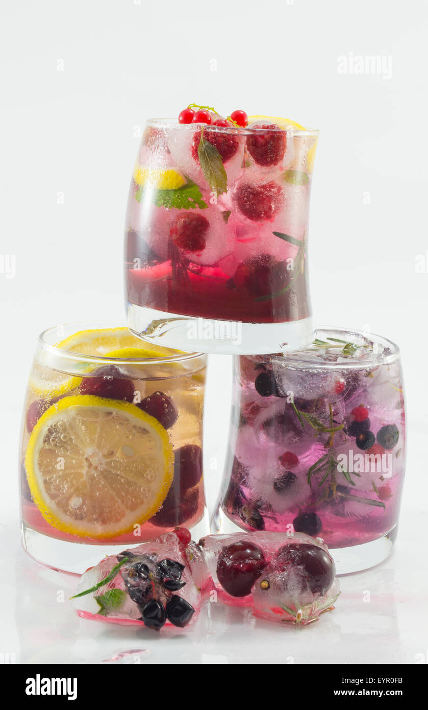 Three natural and non alcoholic fruit cocktails on top of each other with fruit in ice. Cold summer refreshment Stock Photo