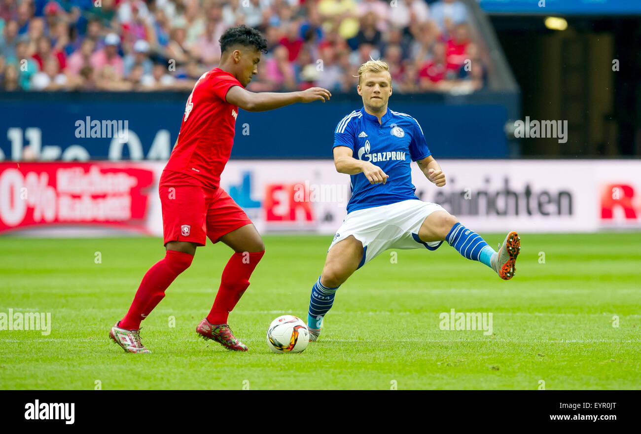 Gelsenkirchen, Germany. 02nd Aug, 2015. Schalke's Johannes Geis (R) and Enscchede's Renato Tapia (L) in action during a soccer friendly match between FC Schalke 04 and FC Twente Enschede at Veltins Arena in Gelsenkirchen, Germany, 02 August 2015. Photo: GUIDO KIRCHNER/dpa/Alamy Live News Stock Photo