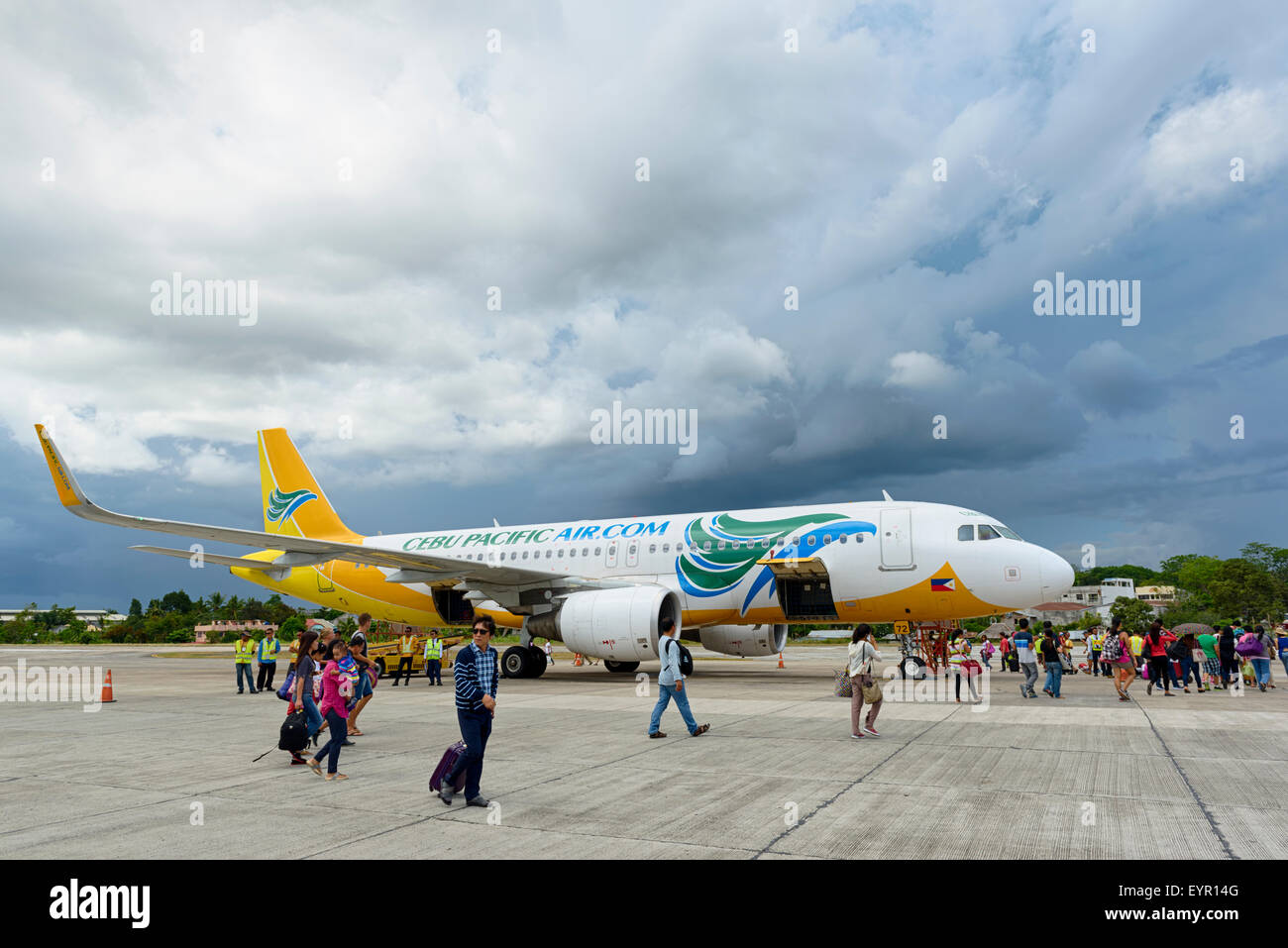 Bohol, Philippines - Jun 1, 2015: Tourists  getting on of a Cebu Pacific Air plane on Tagbilaran Airport on Bohol island, Philip Stock Photo