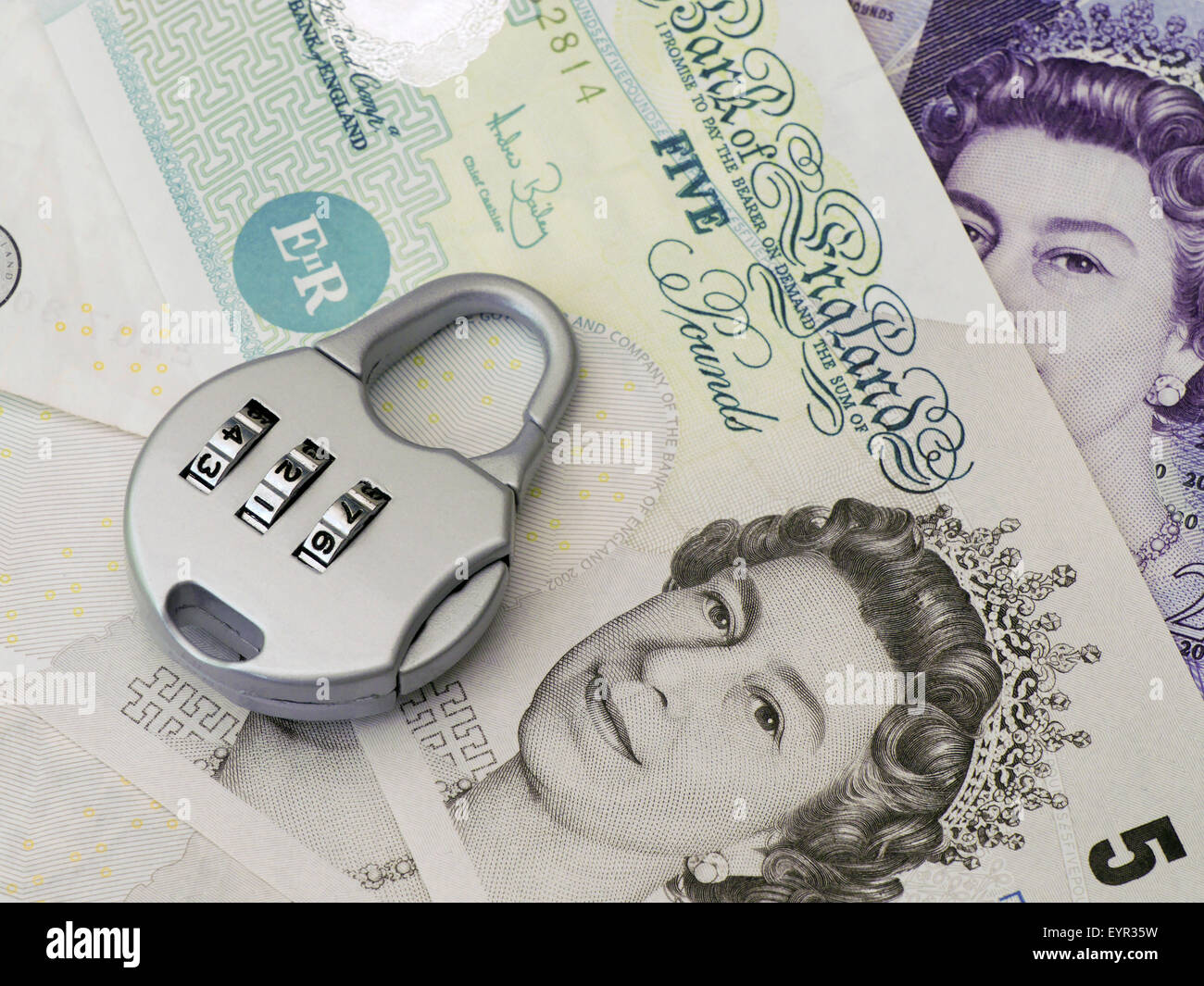 Combination padlock rests on British banknotes Stock Photo Alamy