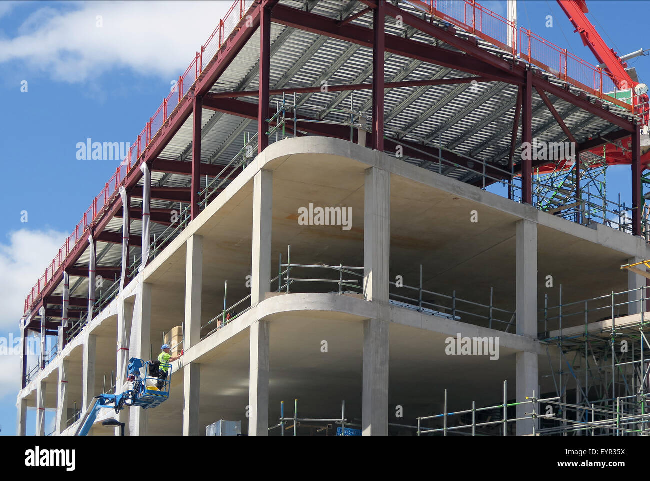 Construction worker using platform picker on new build Stock Photo Alamy
