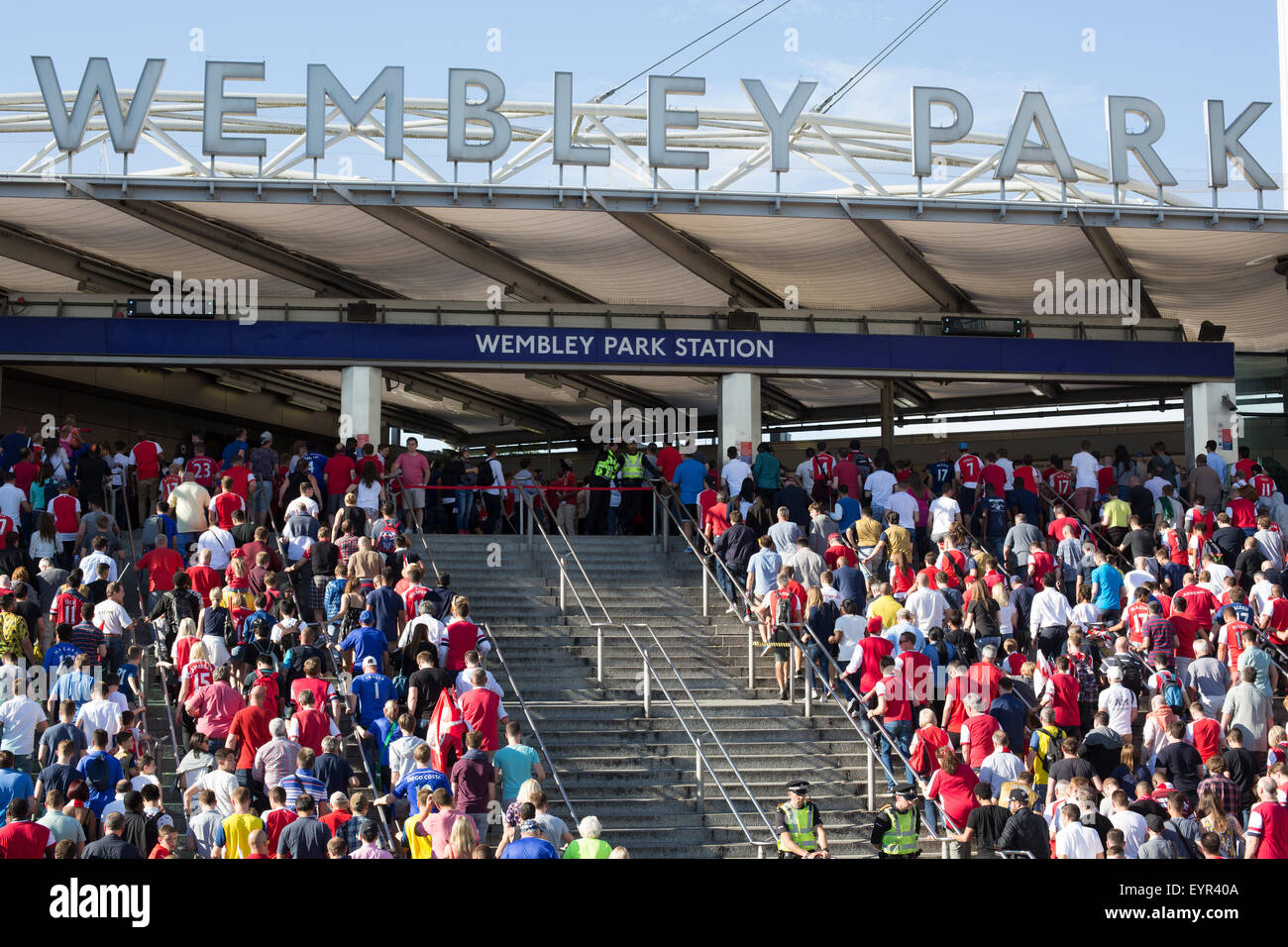 Football supporters climb steps heading into Wembley Park Tube Station