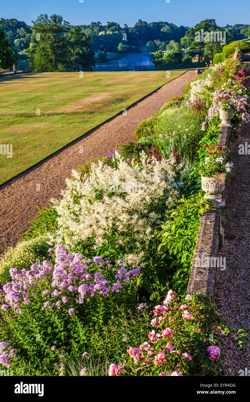 Herbaceous border and parkland below the terrace of Bowood House in Wiltshire. Stock Photo