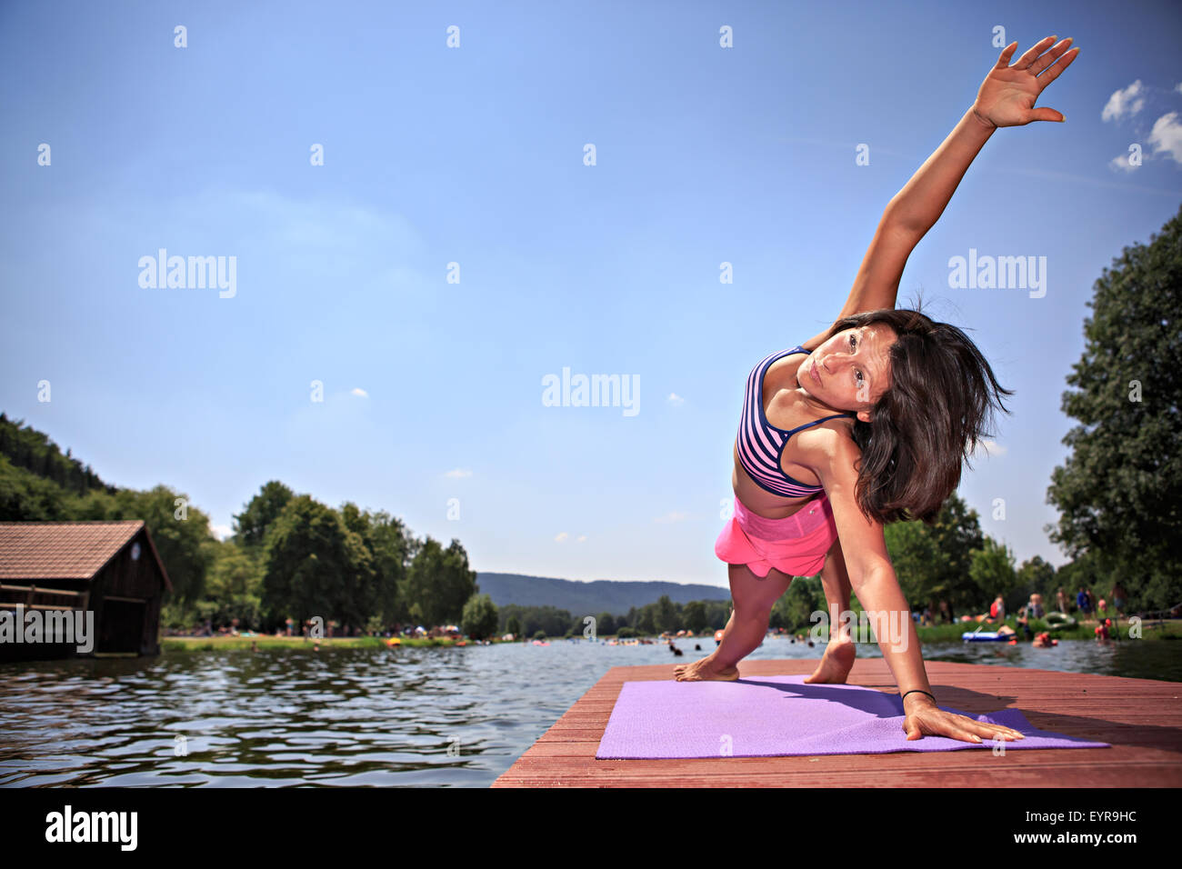 woman making yoga exercise at a lake Stock Photo - Alamy