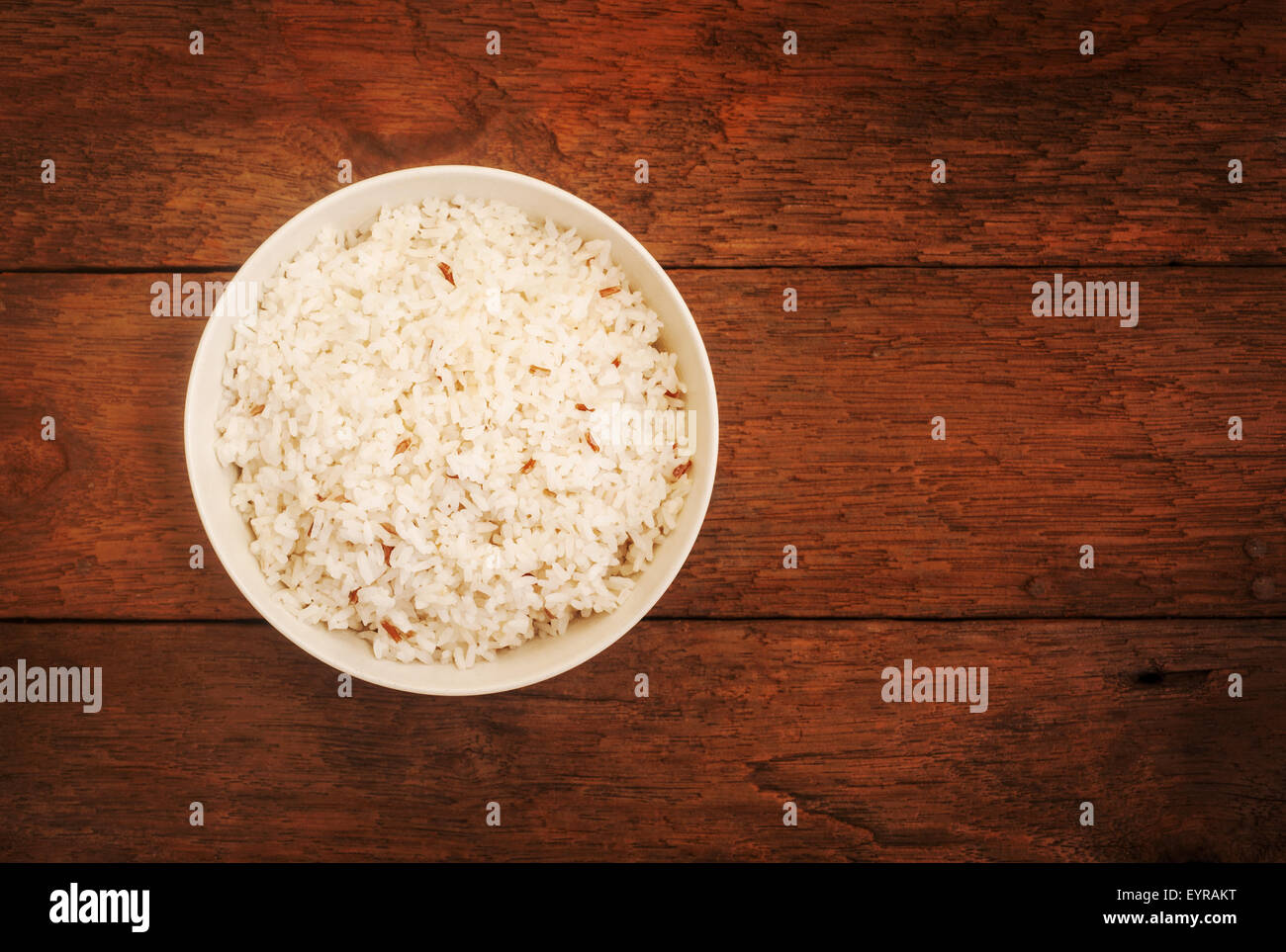 Rice berry, Brown rice in bowl on wood background, selective focus Stock Photo