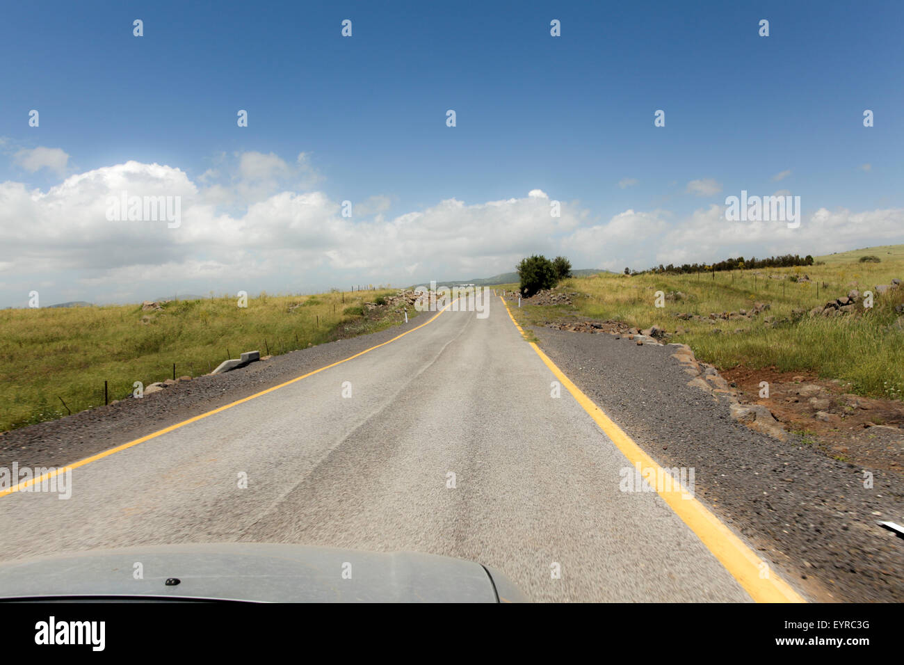 Straight road to vanishing point on the horizon with no traffic. Photographed in the Golan Heights, Israel Stock Photo