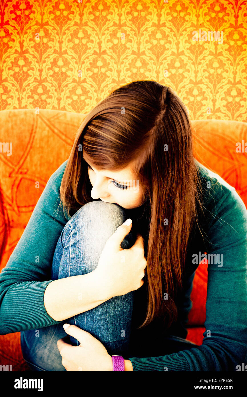 teenager girl sitting on couch sad or thoughtful Stock Photo - Alamy