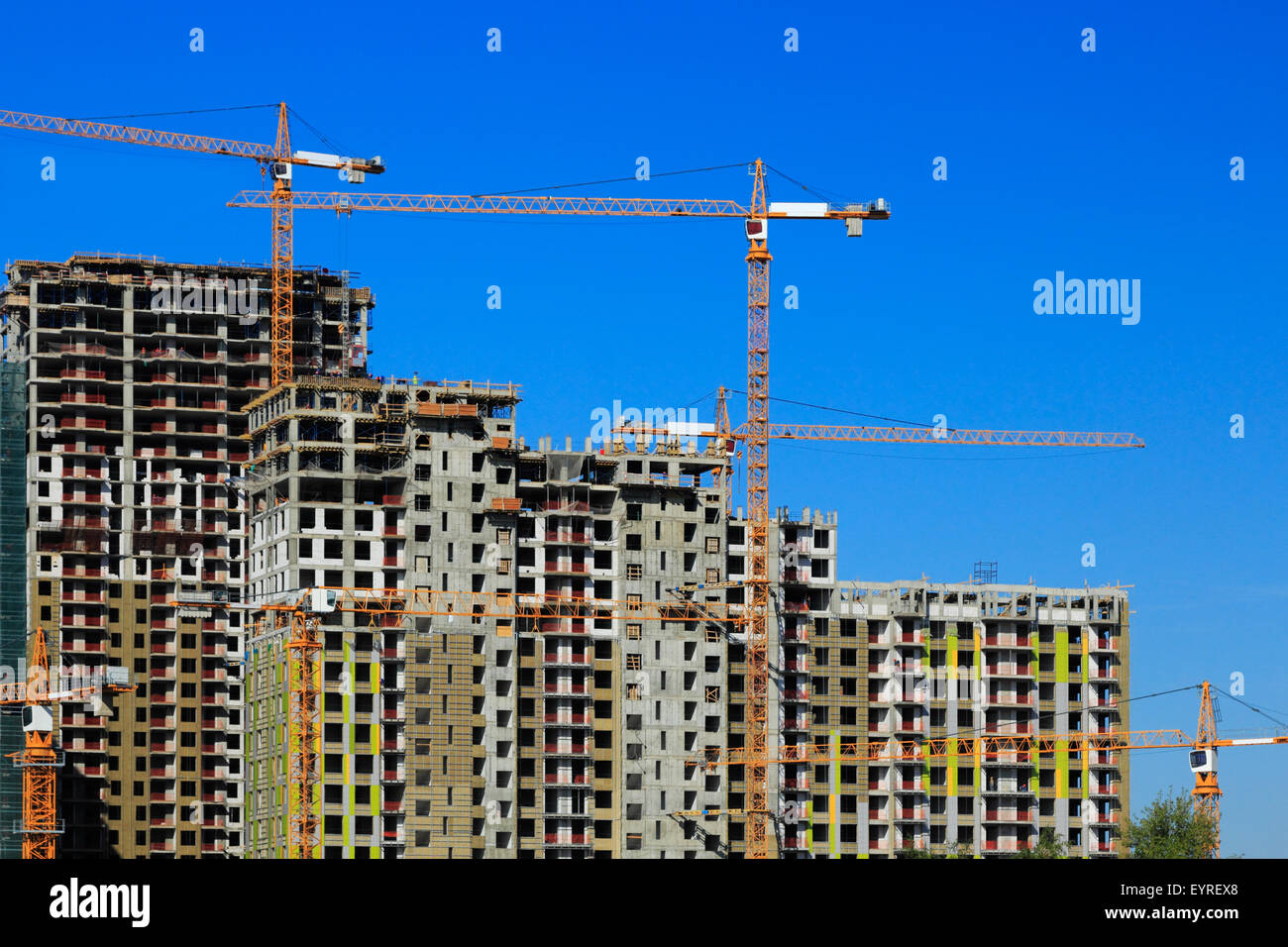 Cranes on construction site of new apartments buildings. Stock Photo