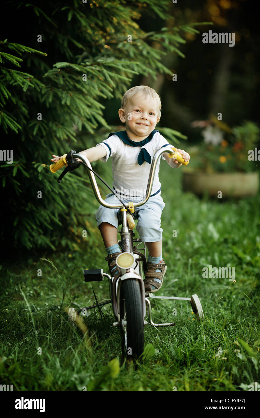 little happy boy on bike Stock Photo