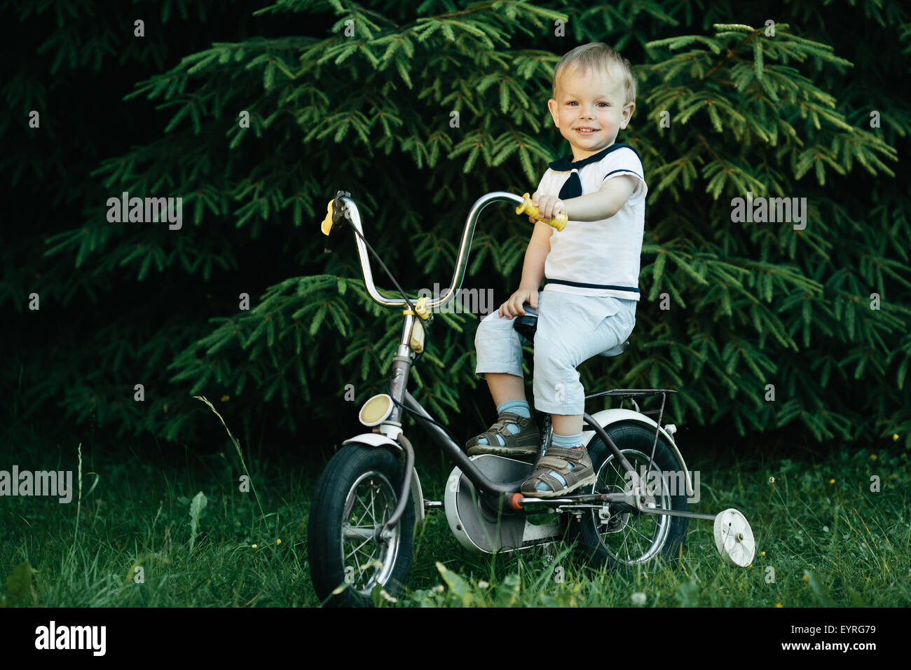 little happy boy on bike Stock Photo