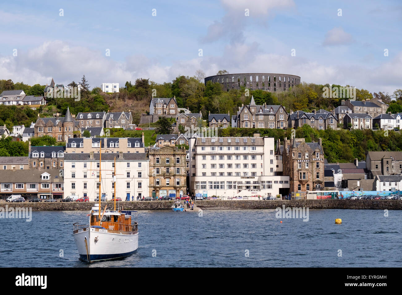 Waterfront buildings with Regent Hotel and War & Peace museum with McCaig's tower folly above. Oban Argyll and Bute Scotland UK Stock Photo