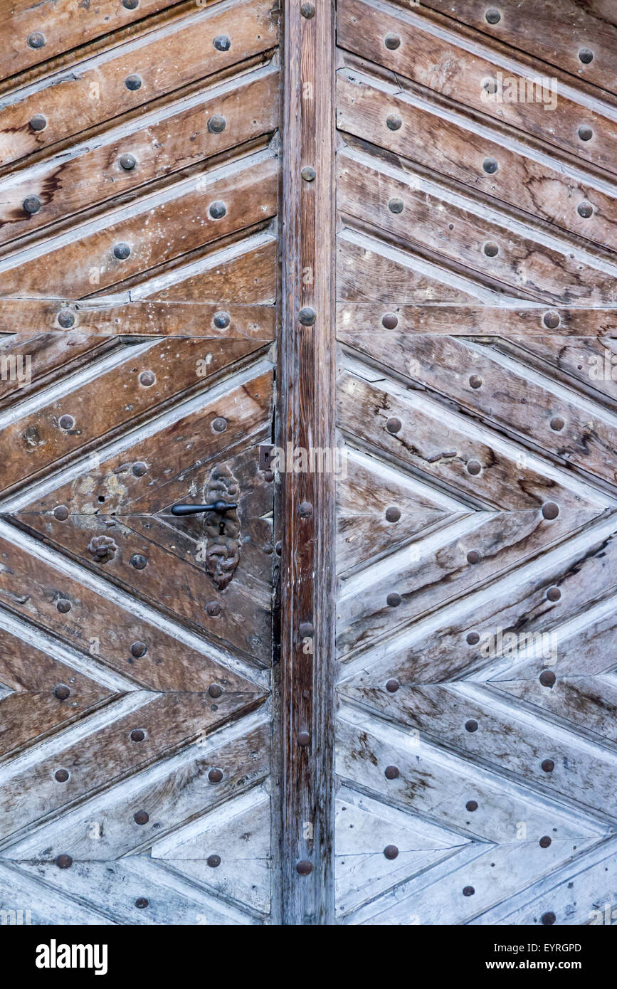 Switzerland. Traditional old style wooden door with geometric design and metal door handle. Stock Photo