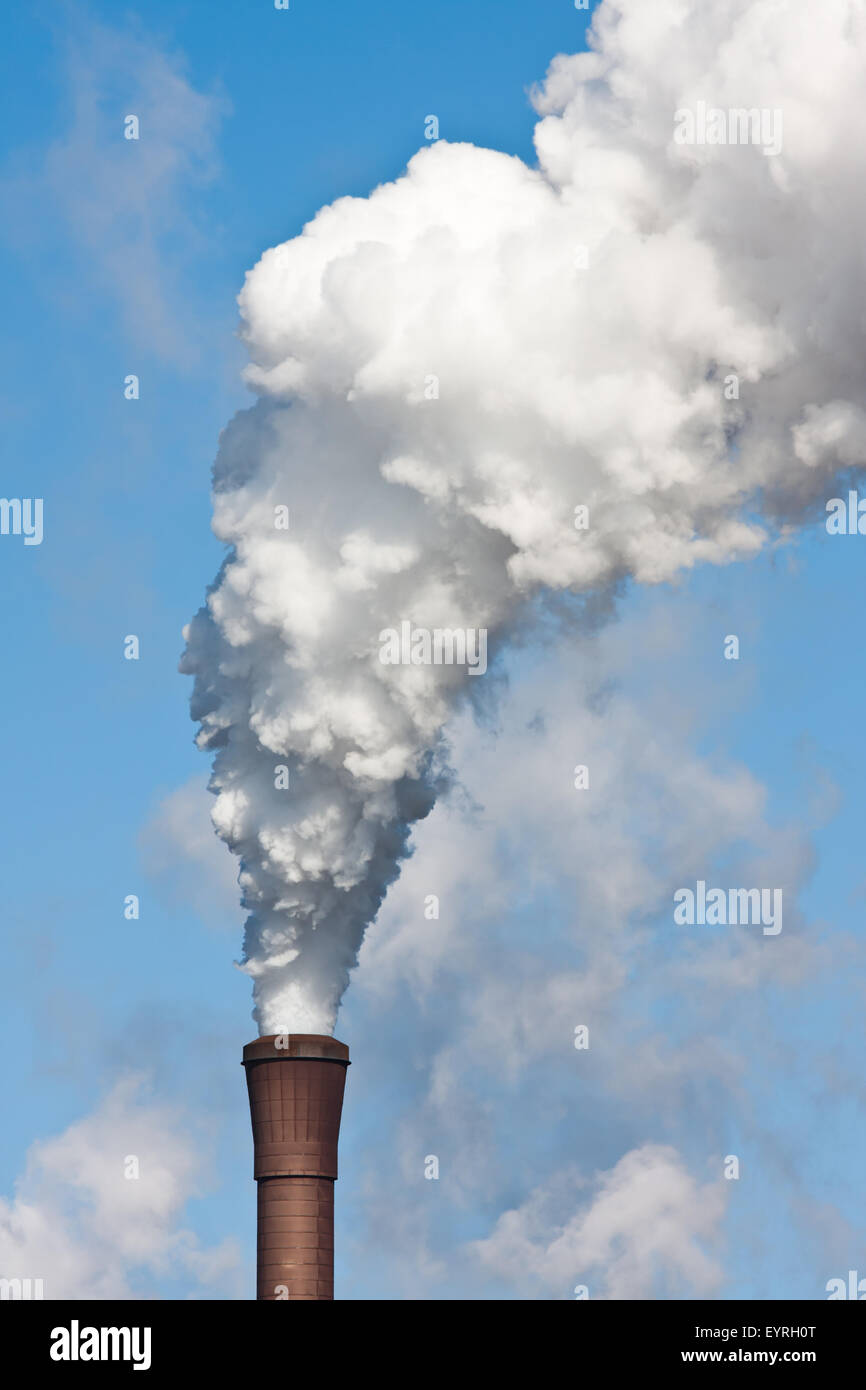 Smokestack with heavy pollution against a blue sky Stock Photo