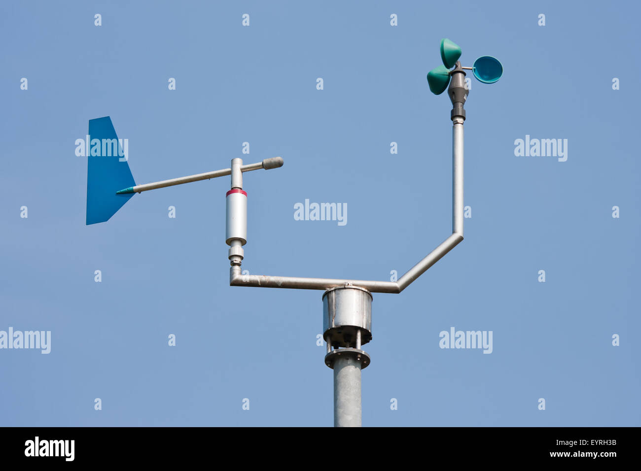 Anemometer measuring wind speed and direction with a blue sky in the background Stock Photo