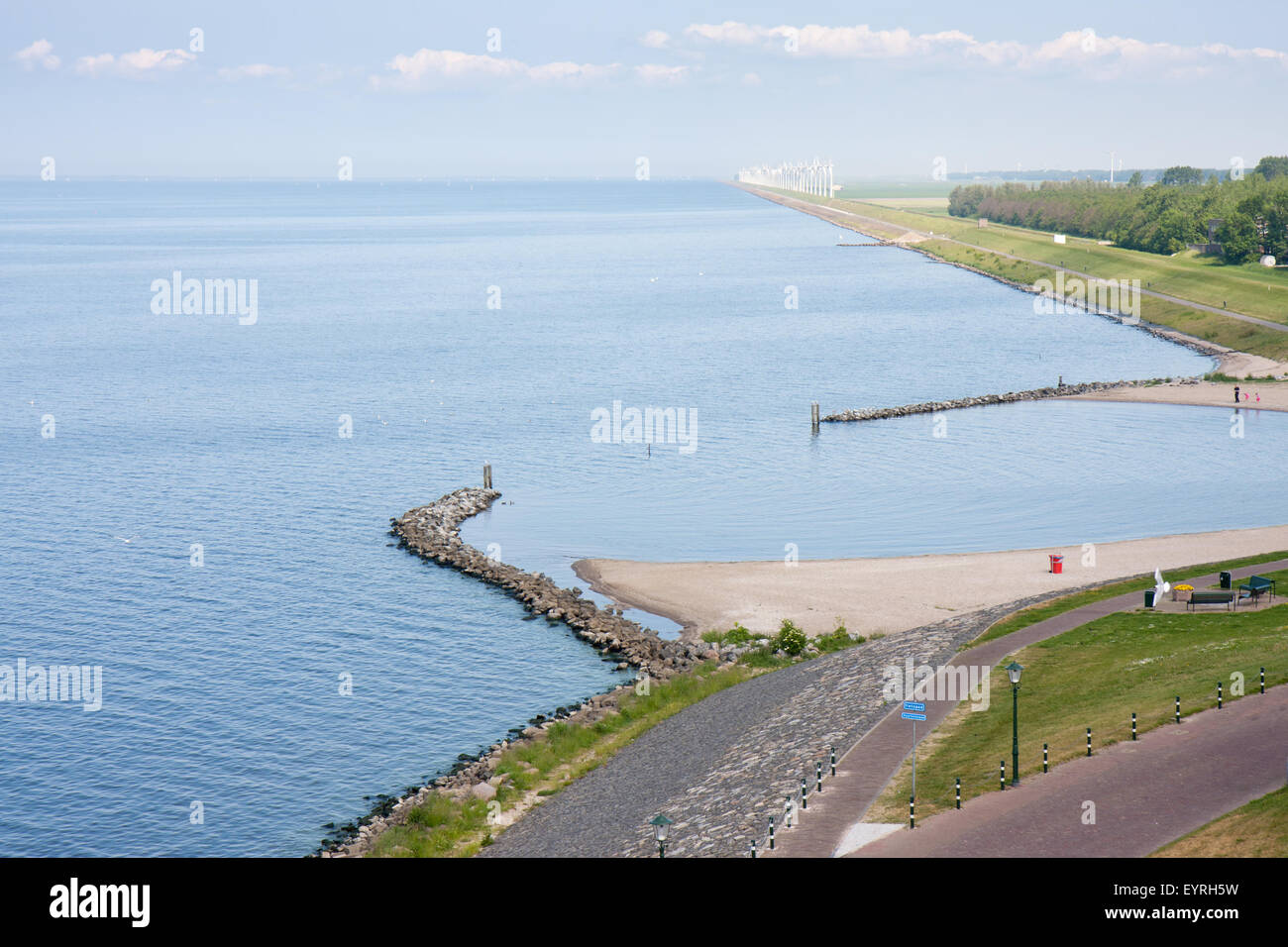 Seafront of a Dutch town with in front a big wind farm Stock Photo