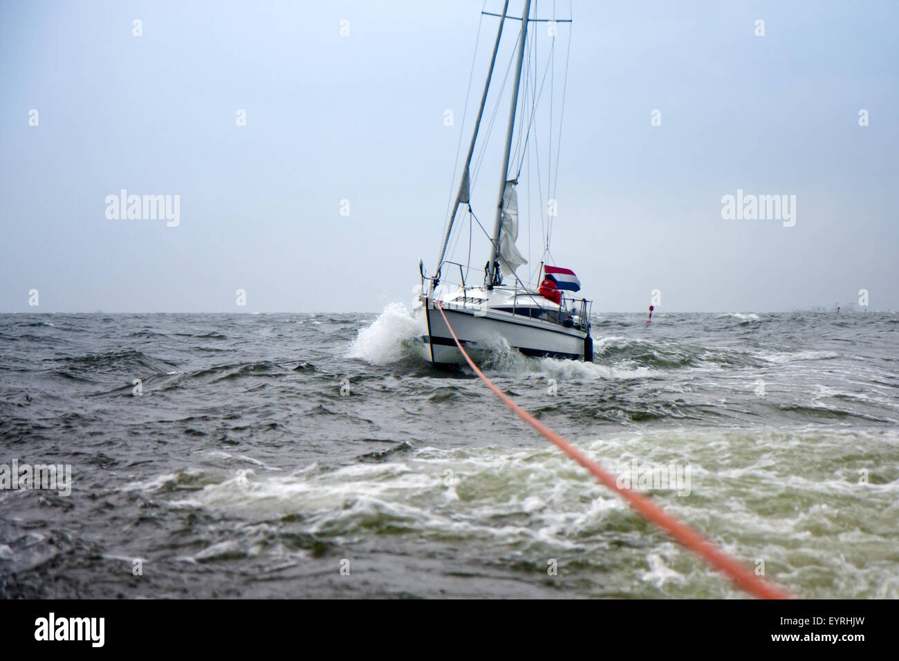 Dutch Yacht in misery be on tow to a safe harbor Stock Photo