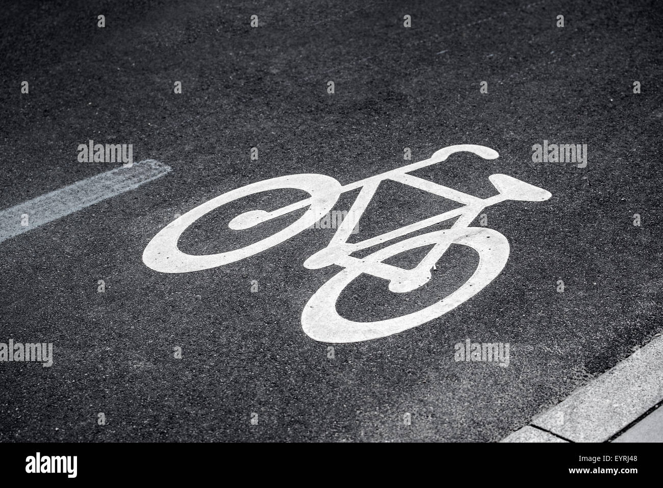 Bike Lane Sign on Asphalt Road Marking the Space for Cycling in Urban Outdoor Setting Stock Photo