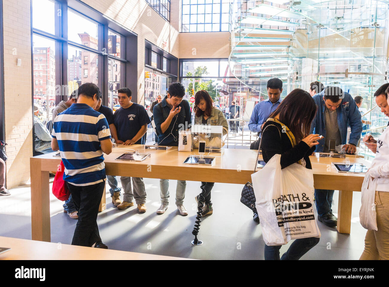 New York City, USA, People inside Apple Store in Manhattan, Trying new equipment, Consumer Products, apple showroom, smart phones public crowd, teenager group shopping store buying, shopper iphone Stock Photo