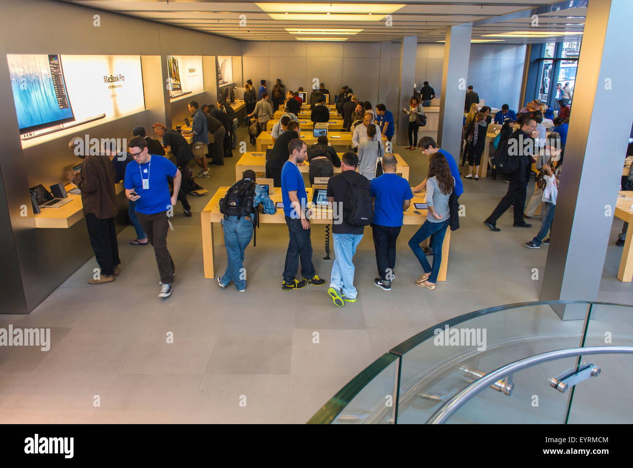 New York City, USA, Large Crowd People Customers Shopping inside Apple Store in Manhattan, using new exciting technology apple showroom. shopper iphone Stock Photo