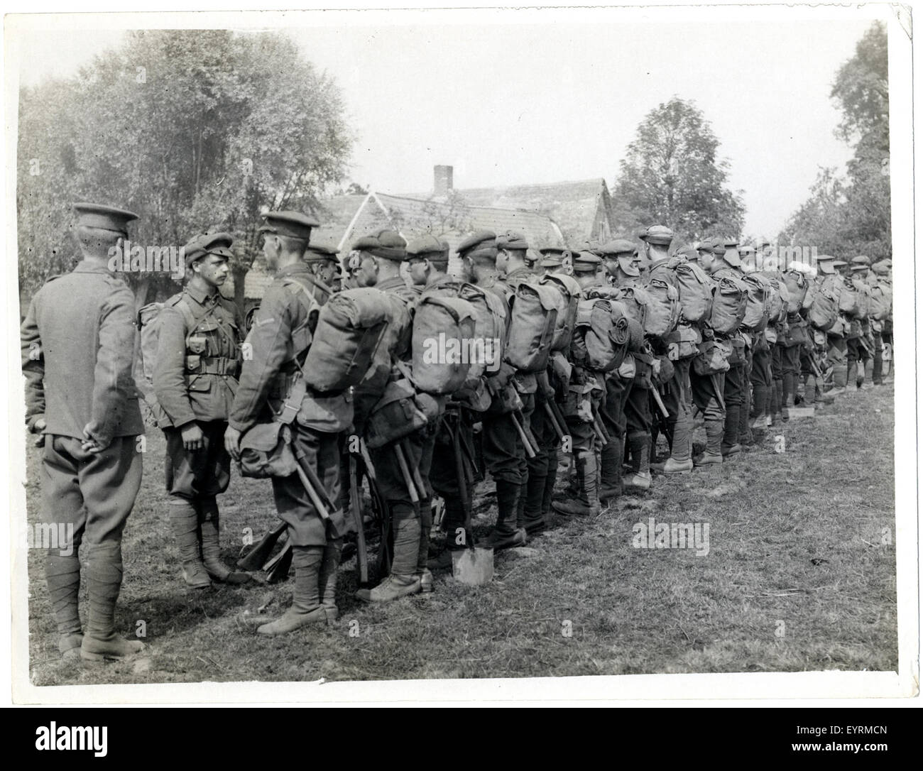 Platoon parading outside their billets before marching off to the Stock